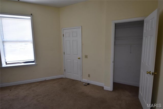 7617 Ivory Ave, Saint Louis, MO 63111 - unfurnished bedroom featuring carpet flooring, multiple windows, baseboards, and a closet