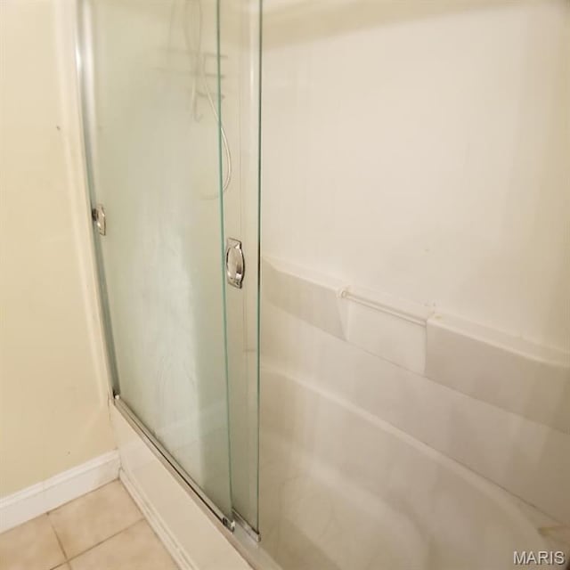 7617 Ivory Ave, Saint Louis, MO 63111 - bathroom featuring a shower with door, tile patterned flooring, a tub, and baseboards