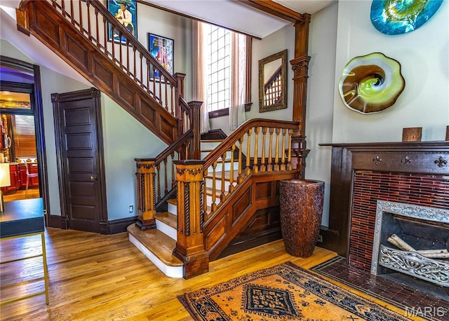 3630 Flad Ave, Saint Louis, MO 63110 - stairs featuring wood finished floors and a tiled fireplace