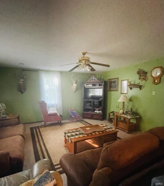living room with a textured ceiling and a ceiling fan