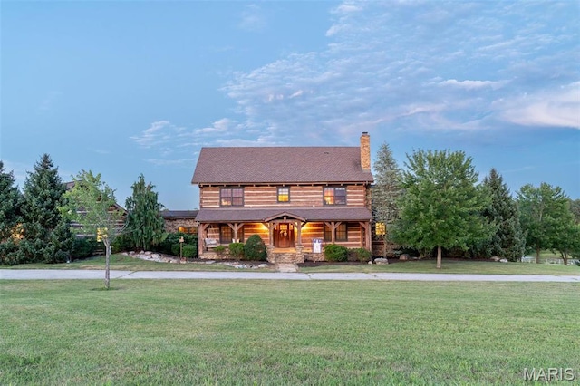 5140 Saint Anns Rd, Washington, MO 63090 - log home with covered porch, a front yard, and a chimney