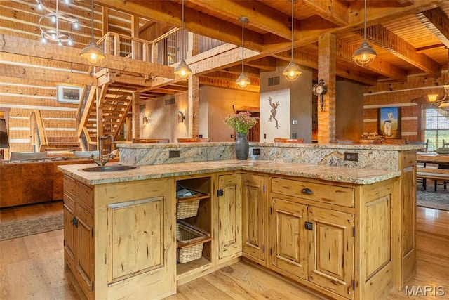 5140 Saint Anns Rd, Washington, MO 63090 - kitchen with a sink, open floor plan, light wood-style flooring, decorative light fixtures, and light stone countertops