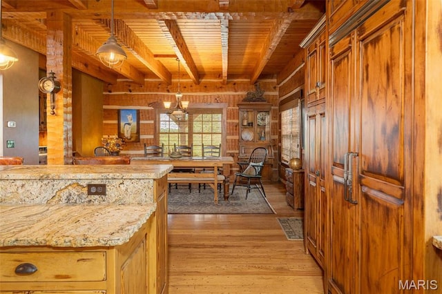 5140 Saint Anns Rd, Washington, MO 63090 - kitchen with wooden ceiling with exposed beams, wooden walls, light wood-style flooring, pendant lighting, and light stone counters