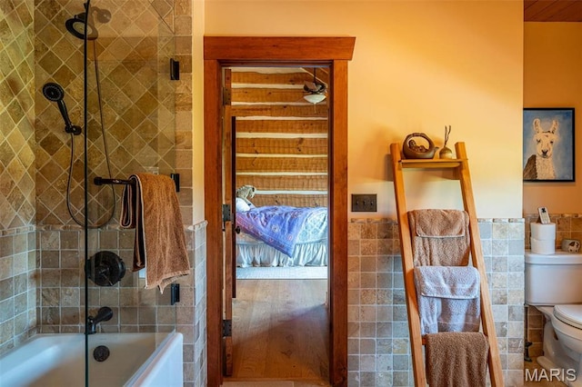 5140 Saint Anns Rd, Washington, MO 63090 - full bathroom featuring tile walls, toilet, bath / shower combo with glass door, wainscoting, and ensuite bath