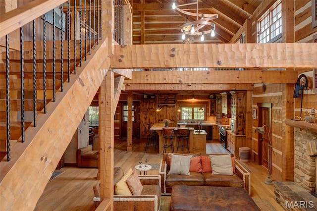 5140 Saint Anns Rd, Washington, MO 63090 - living area with high vaulted ceiling, hardwood / wood-style flooring, wooden walls, wood ceiling with exposed beams, and stairway