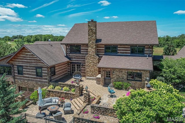 5140 Saint Anns Rd, Washington, MO 63090 - view of front facade with a patio, a chimney, an outdoor living space, stone siding, and roof with shingles