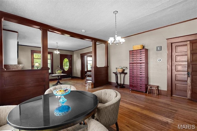 302 E Walsh St, Montgomery City, MO 63361 - dining space featuring wood finished floors, plenty of natural light, a textured ceiling, ornamental molding, and a chandelier