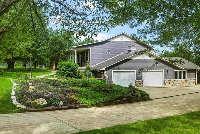 547 County Road 448, Poplar Bluff, MO 63901 - view of home's exterior featuring concrete driveway, a garage, and stone siding