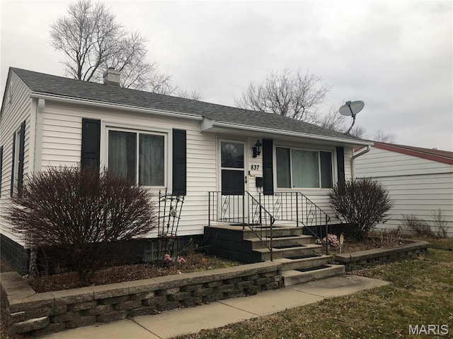 837 N 70th St E, St Louis, IL 62203 - view of front of property featuring a chimney and a shingled roof