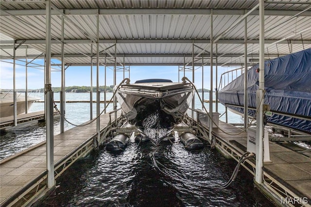 dock featuring boat lift and a water view