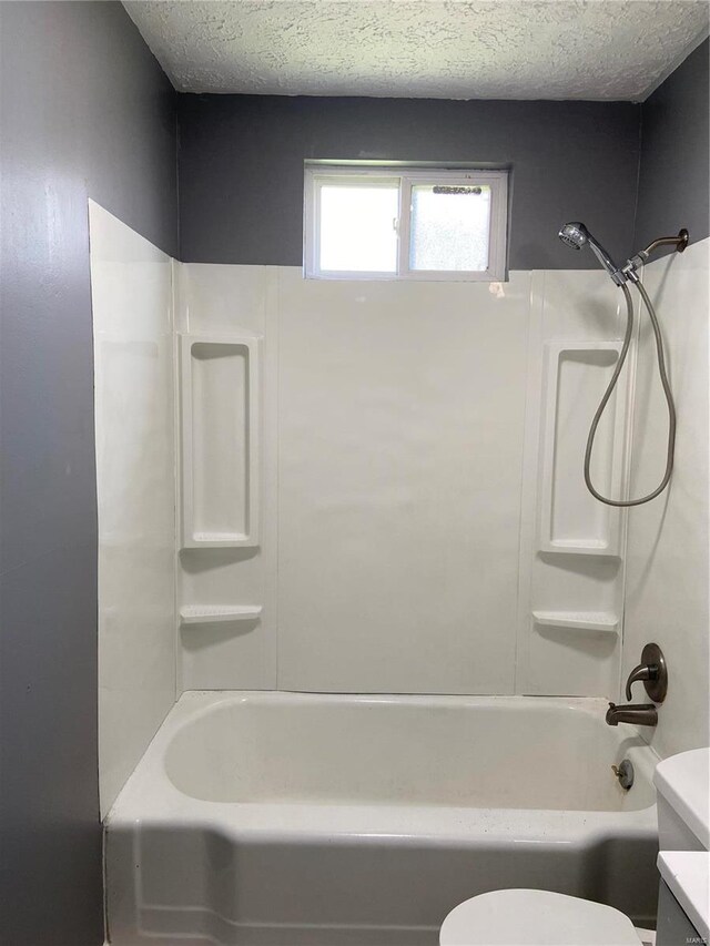 2600 E 25th St, Granite City, IL 62040 - bathroom with toilet, shower / tub combination, and a textured ceiling