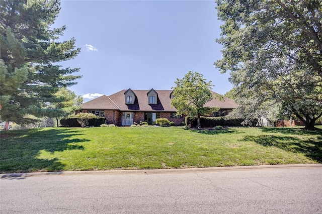 new england style home featuring a front yard