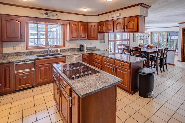 kitchen featuring a sink, black electric cooktop, healthy amount of natural light, stainless steel dishwasher, and ornamental molding