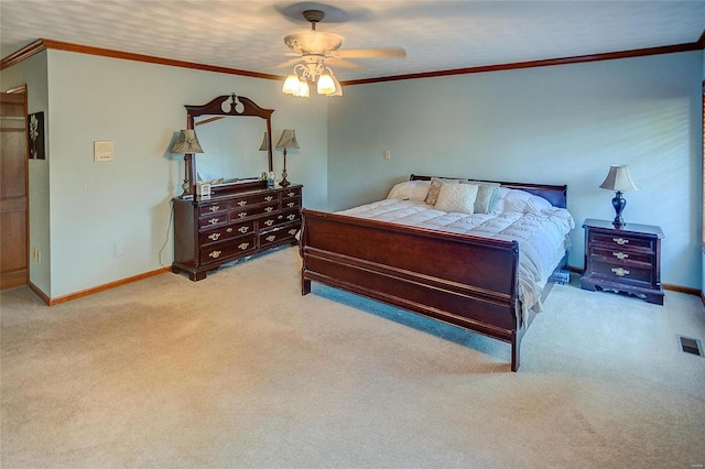 bedroom with carpet floors, baseboards, ornamental molding, and a ceiling fan