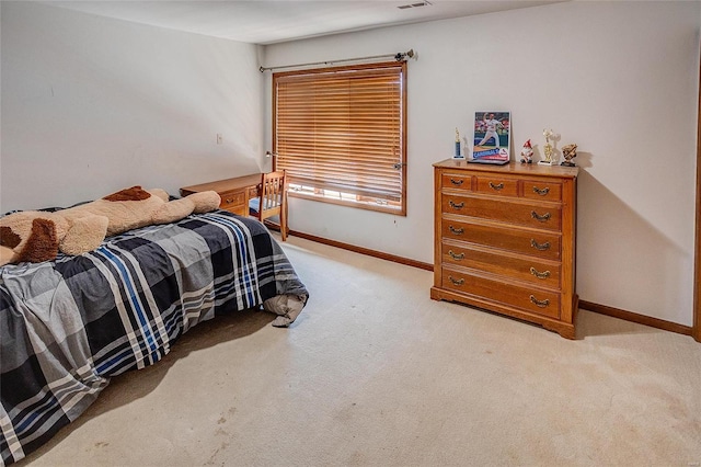 bedroom with light carpet and baseboards