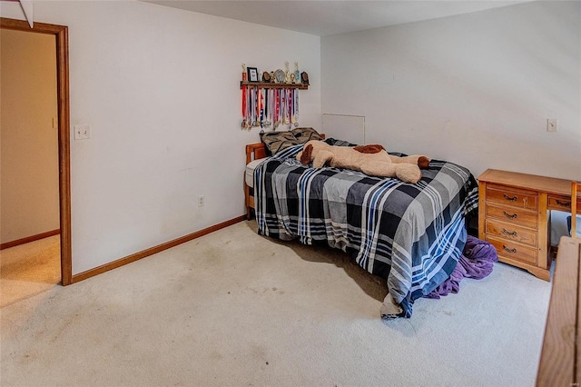 carpeted bedroom featuring baseboards