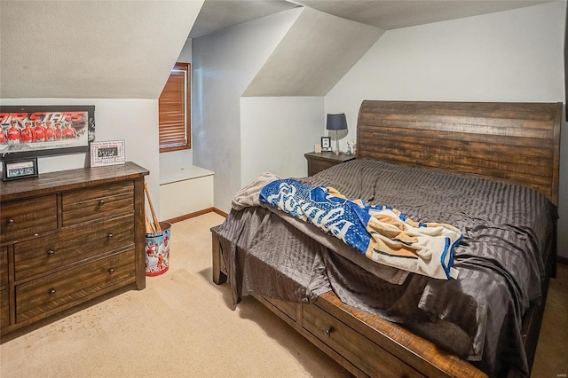 bedroom featuring light colored carpet, vaulted ceiling, and baseboards