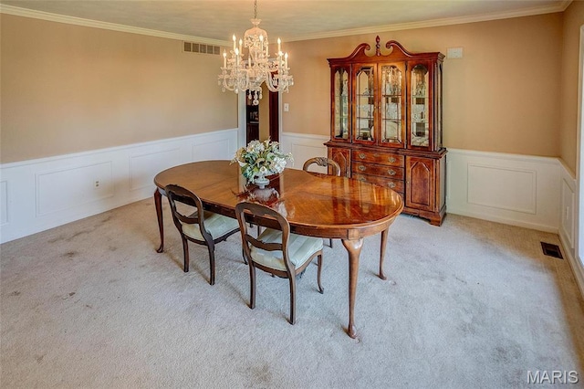 6 Red Fox Rd, Belleville, IL 62223 - dining space featuring a chandelier, light colored carpet, wainscoting, a decorative wall, and crown molding