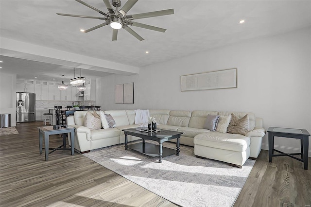 living area with ceiling fan, dark wood finished floors, and recessed lighting