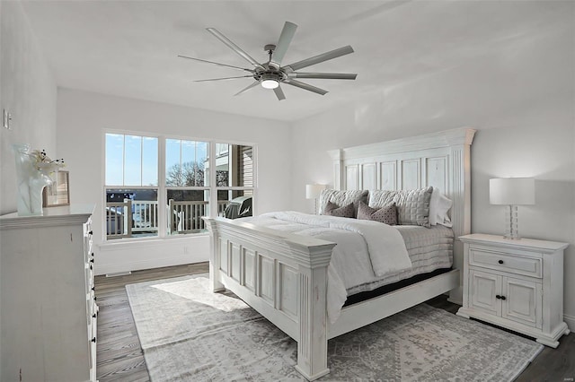 bedroom with dark wood-type flooring, ceiling fan, and baseboards