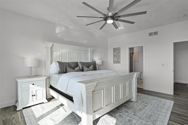 bedroom featuring baseboards, dark wood finished floors, and ceiling fan