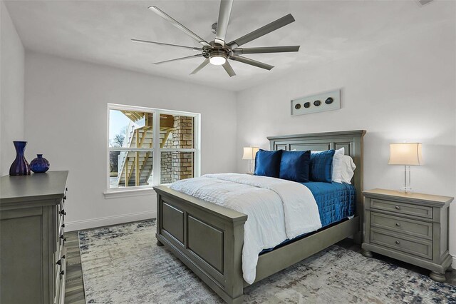 bedroom with baseboards, light wood-style floors, and ceiling fan