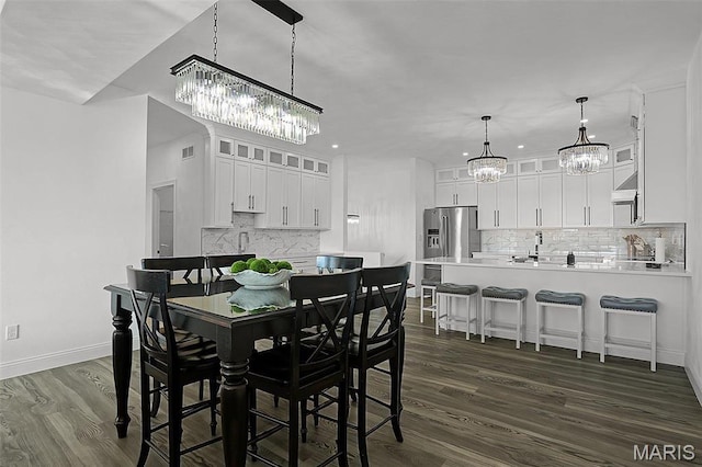 310 Captains Ct, Grafton, IL 62037 - dining area with a chandelier, dark wood-style flooring, and baseboards