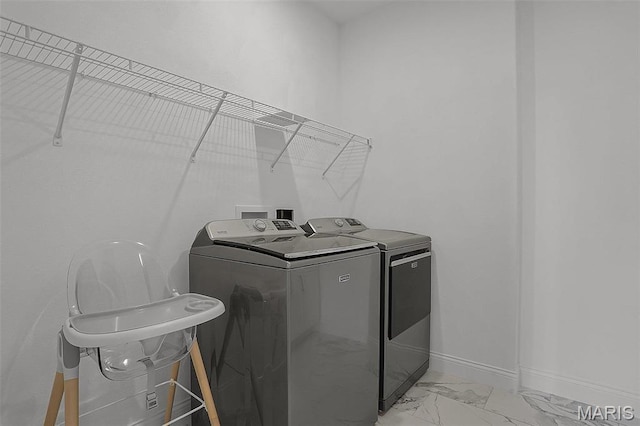 310 Captains Ct, Grafton, IL 62037 - laundry room featuring washer and clothes dryer, light marble finish floors, and baseboards