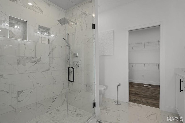 310 Captains Ct, Grafton, IL 62037 - full bath featuring a marble finish shower, marble look tile flooring, baseboards, a spacious closet, and toilet