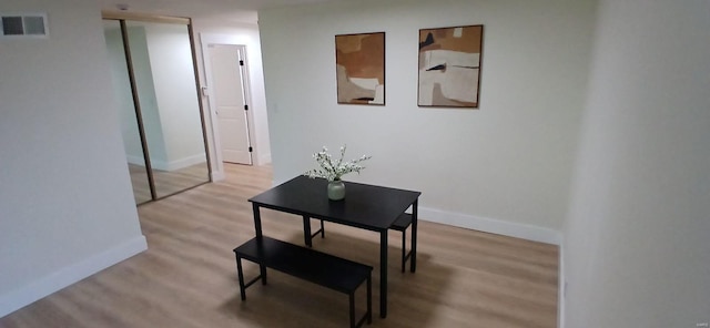 hall featuring wood finished floors and baseboards