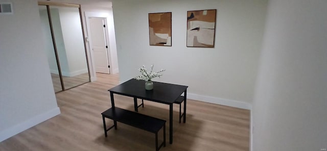 corridor with wood finished floors and baseboards
