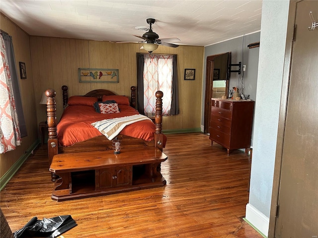 156 S Main St, Ironton, MO 63650 - bedroom with baseboards, wood finished floors, a ceiling fan, and wood walls