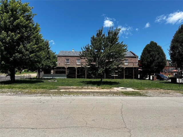 156 S Main St, Ironton, MO 63650 - obstructed view of property featuring brick siding and a front yard