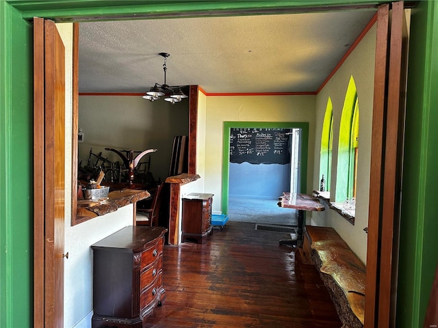 156 S Main St, Ironton, MO 63650 - hallway with a chandelier, dark wood-style floors, a textured ceiling, and ornamental molding