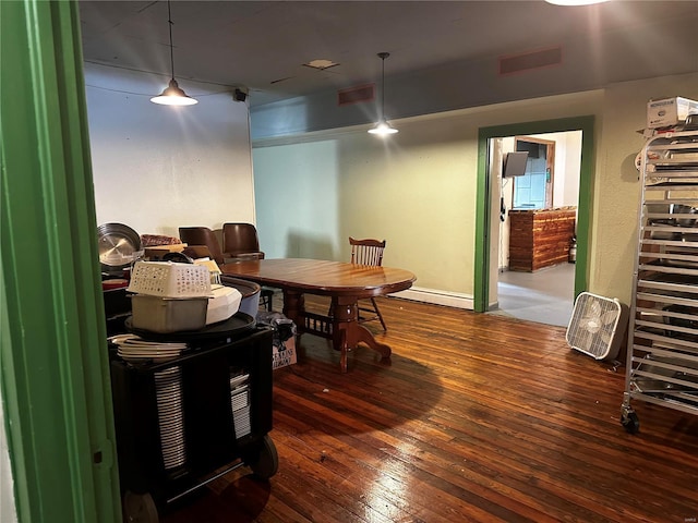 156 S Main St, Ironton, MO 63650 - dining area featuring dark wood-style floors and a baseboard heating unit