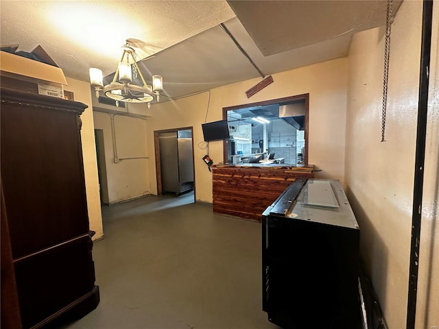 156 S Main St, Ironton, MO 63650 - bedroom with finished concrete floors and a chandelier