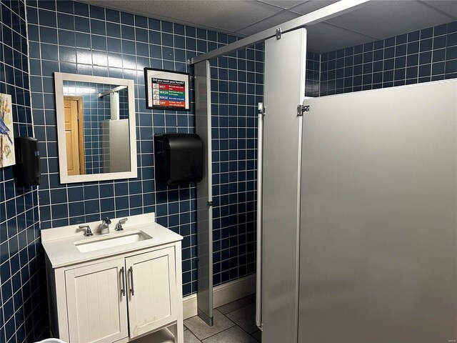 156 S Main St, Ironton, MO 63650 - bathroom featuring tile walls, a stall shower, tile patterned flooring, and vanity