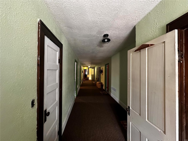 156 S Main St, Ironton, MO 63650 - hallway featuring a textured wall, a textured ceiling, carpet floors, and baseboards