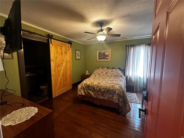 156 S Main St, Ironton, MO 63650 - bedroom with dark wood-type flooring, a textured ceiling, a barn door, crown molding, and ceiling fan