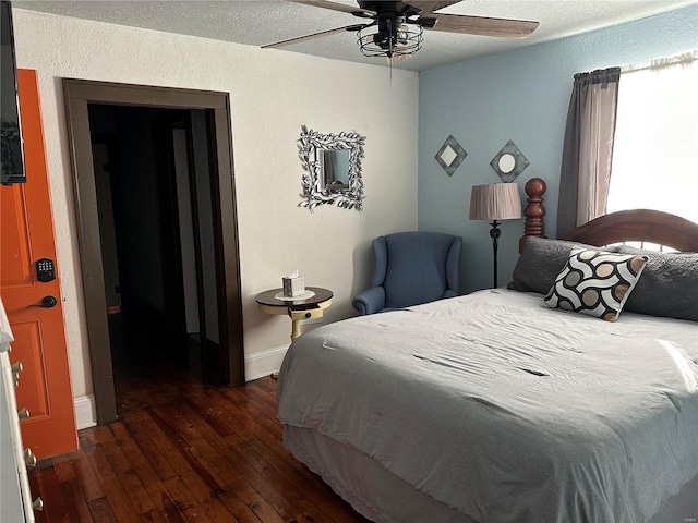 156 S Main St, Ironton, MO 63650 - bedroom with wood-type flooring, ceiling fan, baseboards, a textured wall, and a textured ceiling