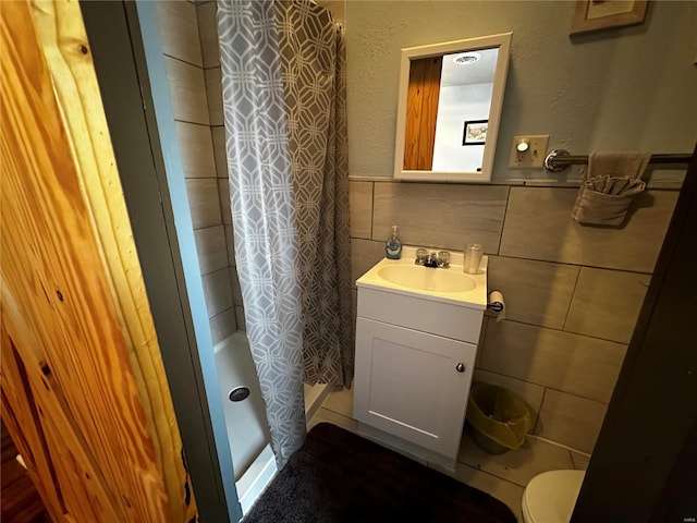 156 S Main St, Ironton, MO 63650 - bathroom featuring tile walls, curtained shower, a wainscoted wall, vanity, and toilet