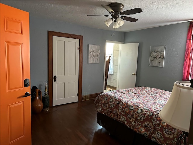156 S Main St, Ironton, MO 63650 - bedroom featuring dark wood-type flooring, a textured ceiling, and a ceiling fan