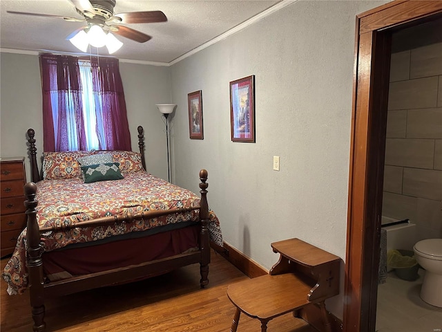 156 S Main St, Ironton, MO 63650 - bedroom featuring crown molding, wood finished floors, a textured ceiling, ceiling fan, and a textured wall