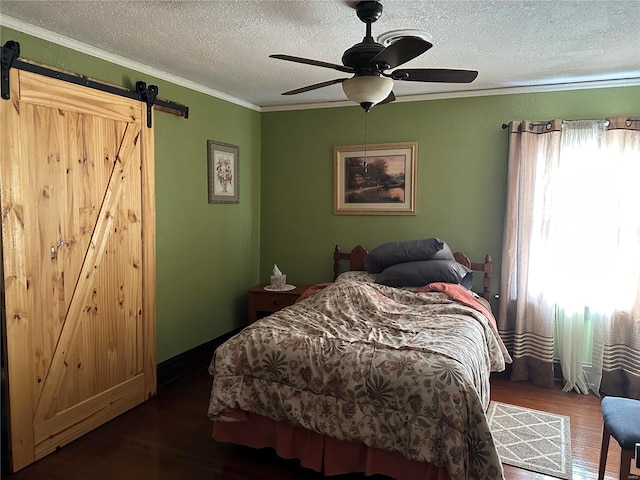 156 S Main St, Ironton, MO 63650 - bedroom featuring a barn door, wood finished floors, a textured ceiling, ornamental molding, and a ceiling fan