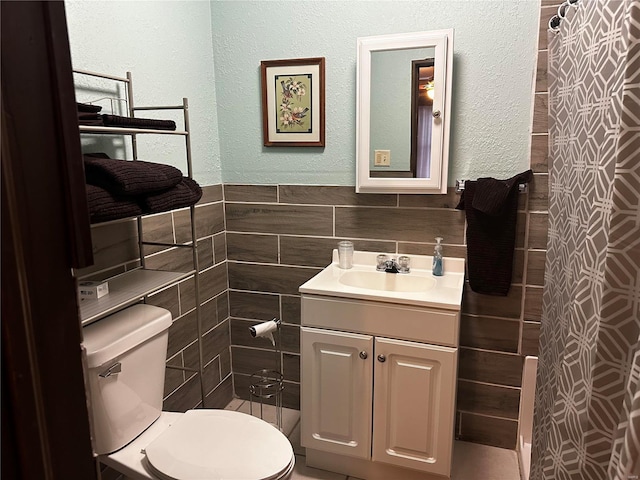 156 S Main St, Ironton, MO 63650 - bathroom with tile walls, toilet, vanity, a textured wall, and a shower with curtain
