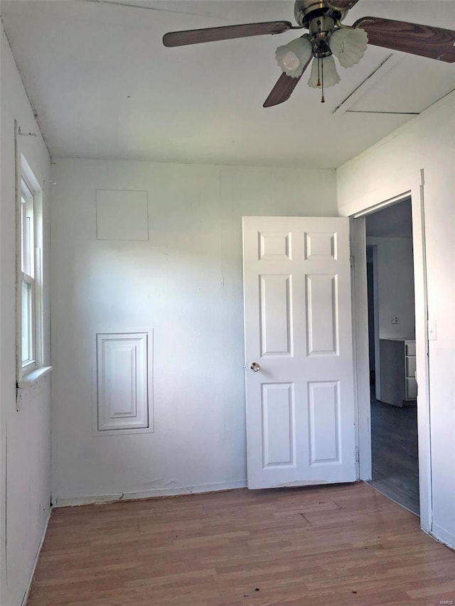 empty room with a ceiling fan and wood finished floors
