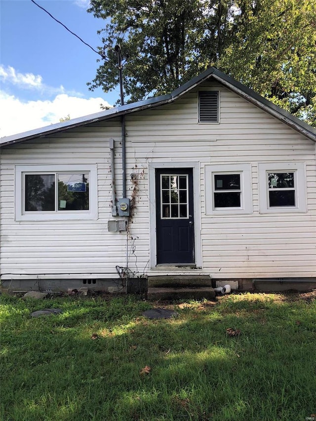 view of front facade with crawl space and a front lawn