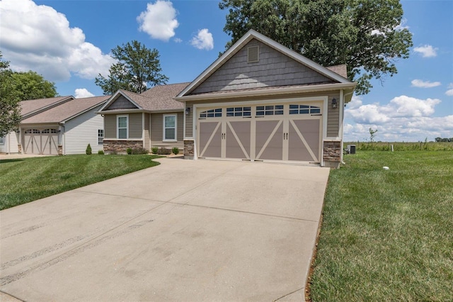 351 Cherry Creek Ln, Farmington, MO 63640 - craftsman house featuring stone siding, driveway, a front yard, and an attached garage