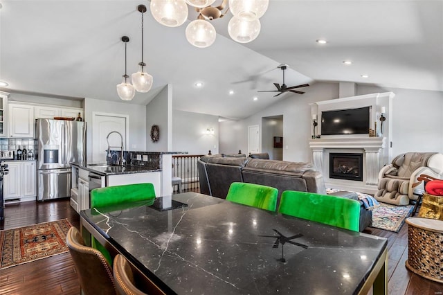 351 Cherry Creek Ln, Farmington, MO 63640 - dining area featuring vaulted ceiling, dark wood-style floors, ceiling fan, a fireplace, and recessed lighting