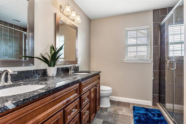351 Cherry Creek Ln, Farmington, MO 63640 - bathroom featuring a stall shower, double vanity, baseboards, and toilet